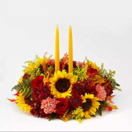 Autumn floral centerpiece with two yellow taper candles