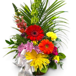 Colorful mixed flower arrangement with a white ribbon bow