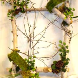 Rustic branch wreath with moss and small green accents