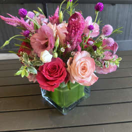 Pink and peach rose bouquet in a clear glass vase