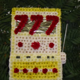 Floral tribute shaped like a bus with red and white flowers