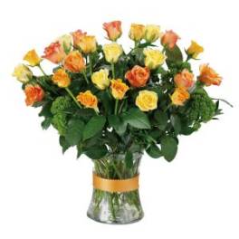Bouquet of yellow and orange roses in a clear glass vase