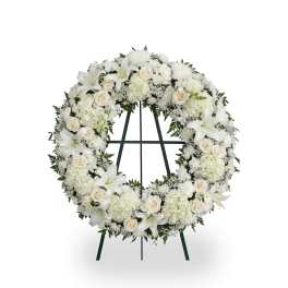 White floral wreath on a standing easel
