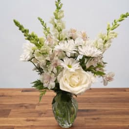 White floral arrangement in a clear glass vase
