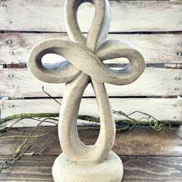Stone knot sculpture on a wooden surface