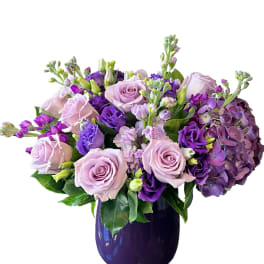 Lavender and purple bouquet in a dark vase