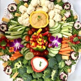 Vegetable platter arranged like a floral display on a white tray
