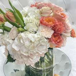 Bouquet of pink and white flowers in a clear glass vase