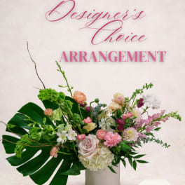 Mixed floral arrangement in a white vase with pink and white blooms