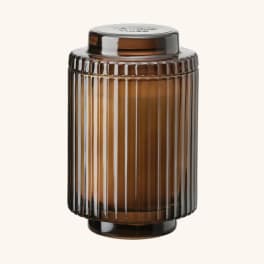 Amber ribbed glass candle jar with a lid