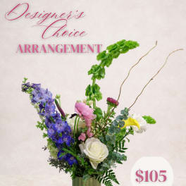 Mixed floral arrangement with blue, pink, white, and yellow blooms