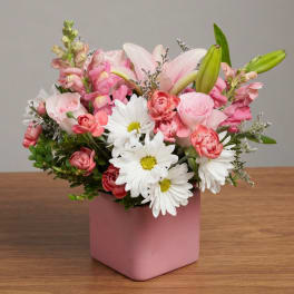 Pink and white mixed bouquet in a pink square vase