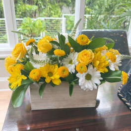 Yellow roses and white daisies in a rectangular wooden planter