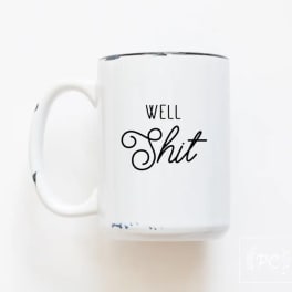 White mug with black text reading "Well Shit"
