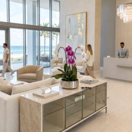 Potted orchids in white and purple arranged on a lobby table