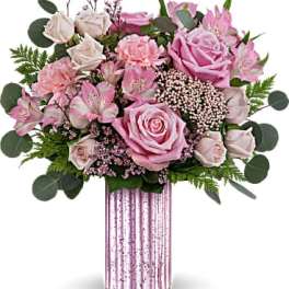 Pink roses and alstroemeria in a tall striped vase