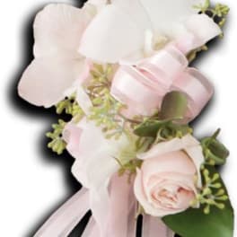 Soft pink and white floral corsage with ribbon