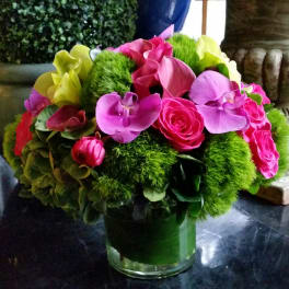 Bright pink and purple bouquet in a glass vase