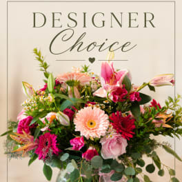 Mixed pink and peach flower arrangement in a glass vase