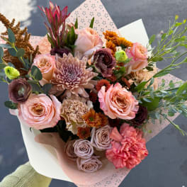 Hand-tied bouquet of pink and peach flowers with mixed blooms