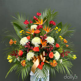Large tropical floral arrangement with roses, chrysanthemums, and bird-of-paradise