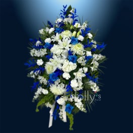 Blue and white floral spray with ribbon on a dark background