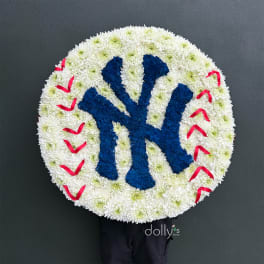Round floral tribute with a blue Yankees logo and red stitching accents