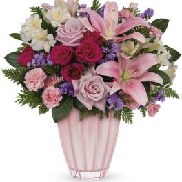 Pink and white mixed bouquet in a pink glass vase