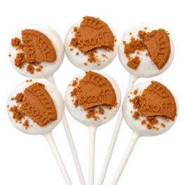 Six white cake pops topped with broken cookie pieces on sticks
