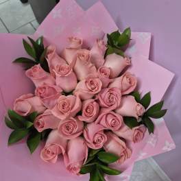 Pink rose bouquet wrapped in pink paper with gold butterfly picks
