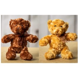 Two plush teddy bears with ribbon bows, one brown and one golden