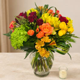 Colorful bouquet of roses and hydrangeas in a glass vase