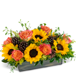 Sunflowers and peach roses arranged in a rectangular wooden box
