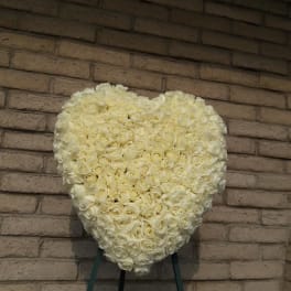 Heart-shaped arrangement of white roses on an easel