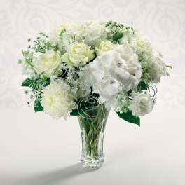 White rose and hydrangea bouquet in a clear glass vase