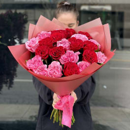 Bouquet of red and pink roses wrapped in pink paper