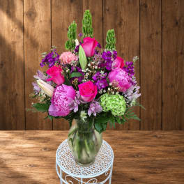 Pink and purple mixed bouquet in a clear glass vase