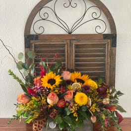 Mixed bouquet with sunflowers, roses, and mums in a wooden box