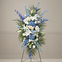 Tall blue and white floral standing spray on an easel