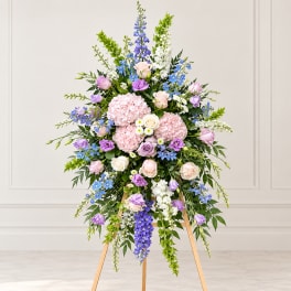Tall pastel floral standing spray on a wooden easel