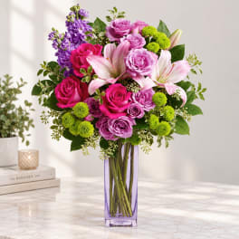 Pink and purple mixed bouquet in a tall purple vase