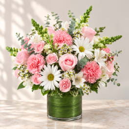 Pink and white mixed bouquet in a green glass vase