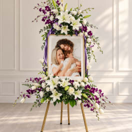 Standing floral frame with white lilies and purple orchids around a photo