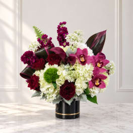 Bouquet of burgundy and pink flowers in a black vase