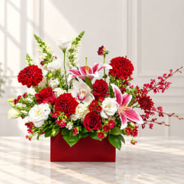 Red and white floral arrangement in a red rectangular box