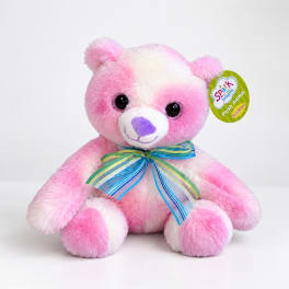 Pink and white plush teddy bear with a striped ribbon bow