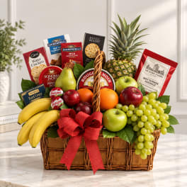 Gift basket with fruit, crackers, cheese, sausage, and a red bow