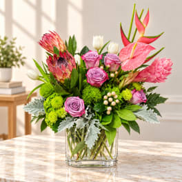 Mixed bouquet in a clear glass vase with pink and white blooms