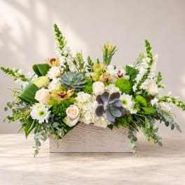 Mixed floral arrangement in a rectangular wood box with white and green blooms