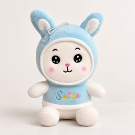 Blue plush bunny toy with a smiling face and the word Smile on its shirt